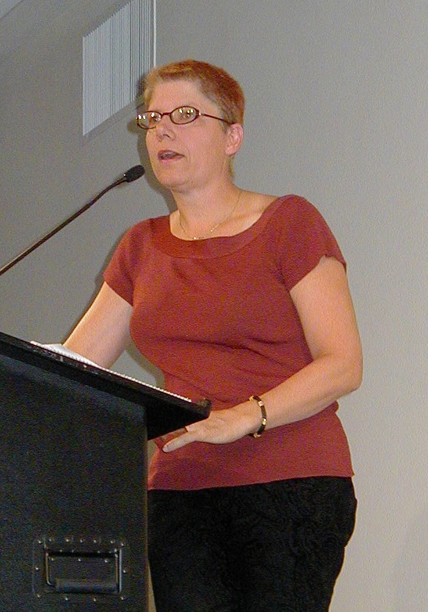 Bo Laurent speaking at a podium
